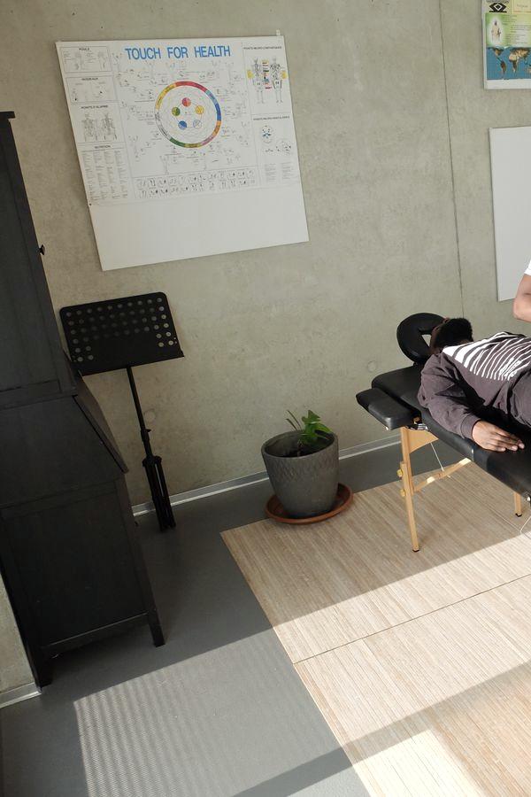 A treatment room with anatomy charts and a table